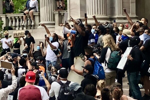 Photo of people holding their fists in the air during the 2020 George Floyd protests
