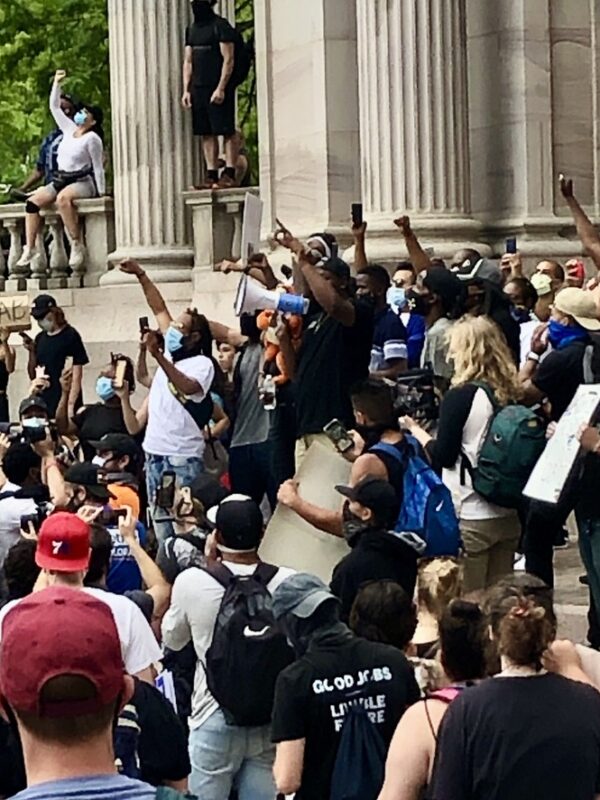 Photo of people holding their fists in the air during the 2020 George Floyd protests