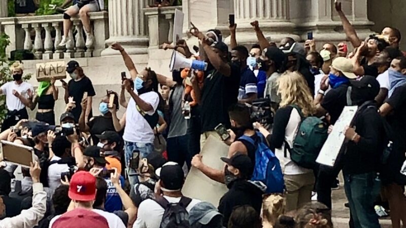 Photo of people holding their fists in the air during the 2020 George Floyd protests