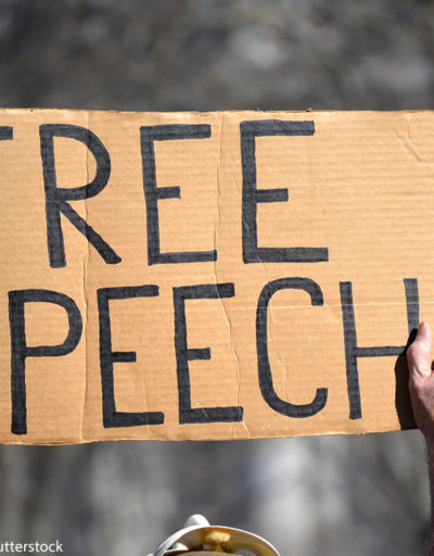 A protest sign that reads "free speech"