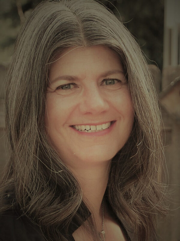 Headshot photo of Jennifer Turner, smiling, in front of a light background