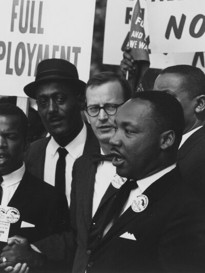 Dr. Martin Luther King Jr. speaking at an event black and white