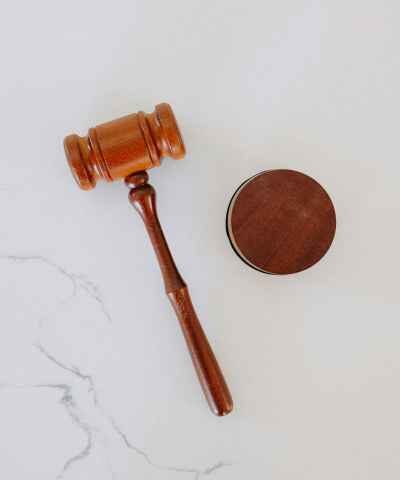 Photo of a gavel laying on white marble