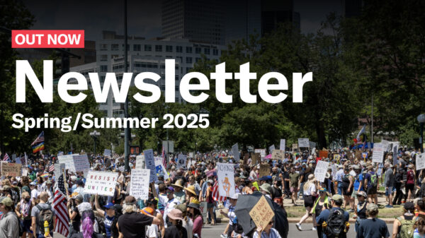 Out now newsletter spring/summer 2025 text over photograph of protesters holding up signs