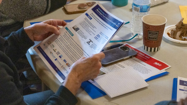 Photo of a person holding pages of printed resources