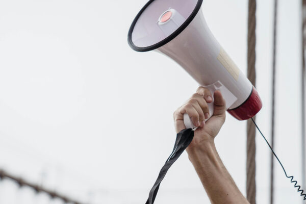Photo of an arm holding a megaphone