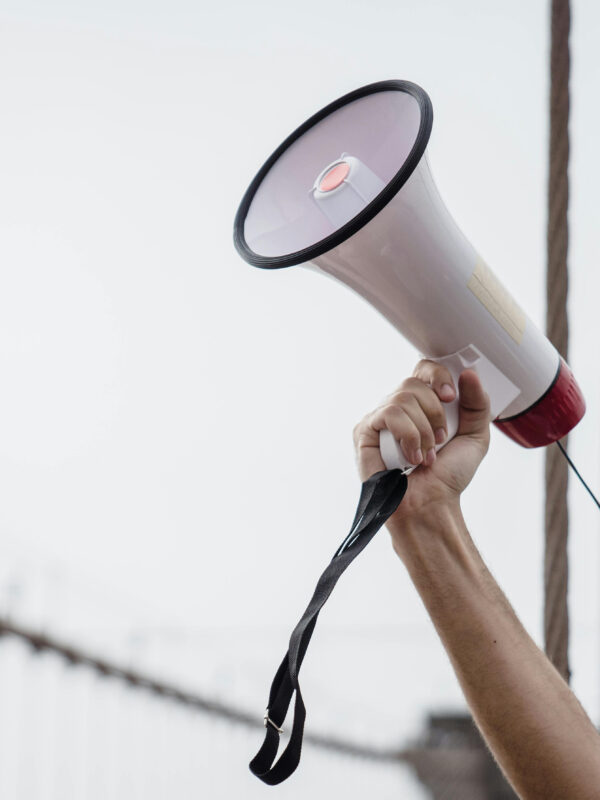 Photo of an arm holding a megaphone