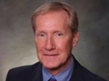 Photo of Pete Lee in front of a light grey background