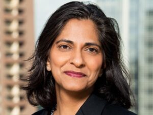 Photo of Vandana Koelsch with highrise buildings in the background