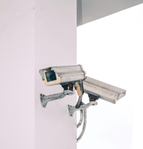 Photo of two security camera attached to a column.