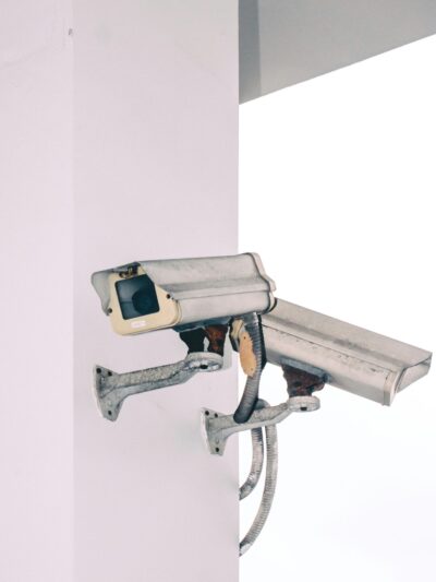 Photo of two security camera attached to a column.