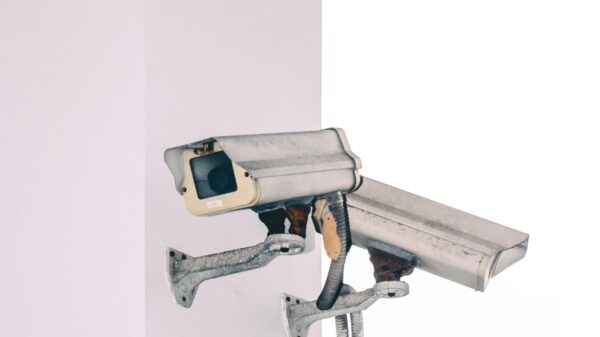 Photo of two security camera attached to a column.