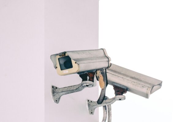 Photo of two security camera attached to a column.