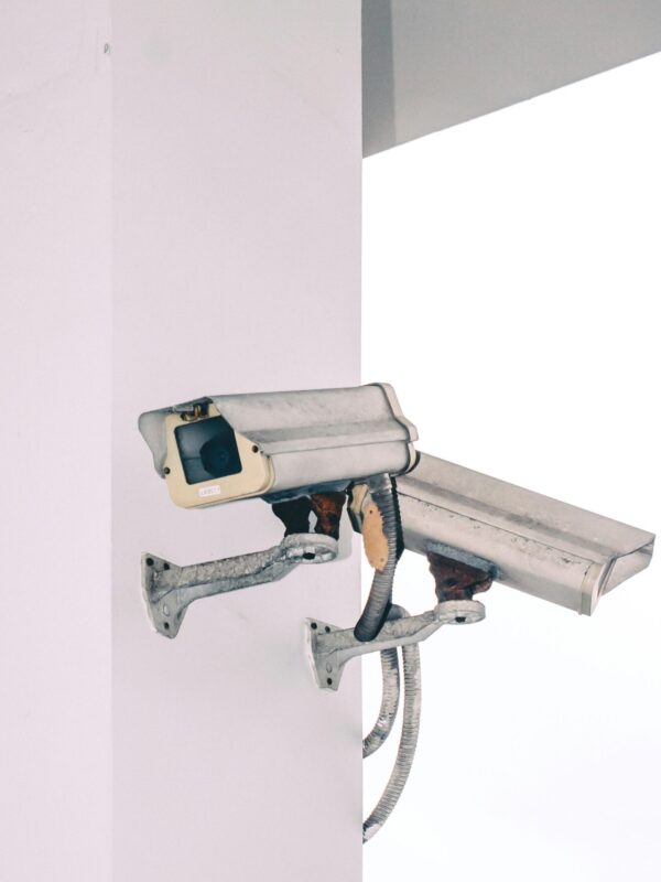 Photo of two security camera attached to a column.