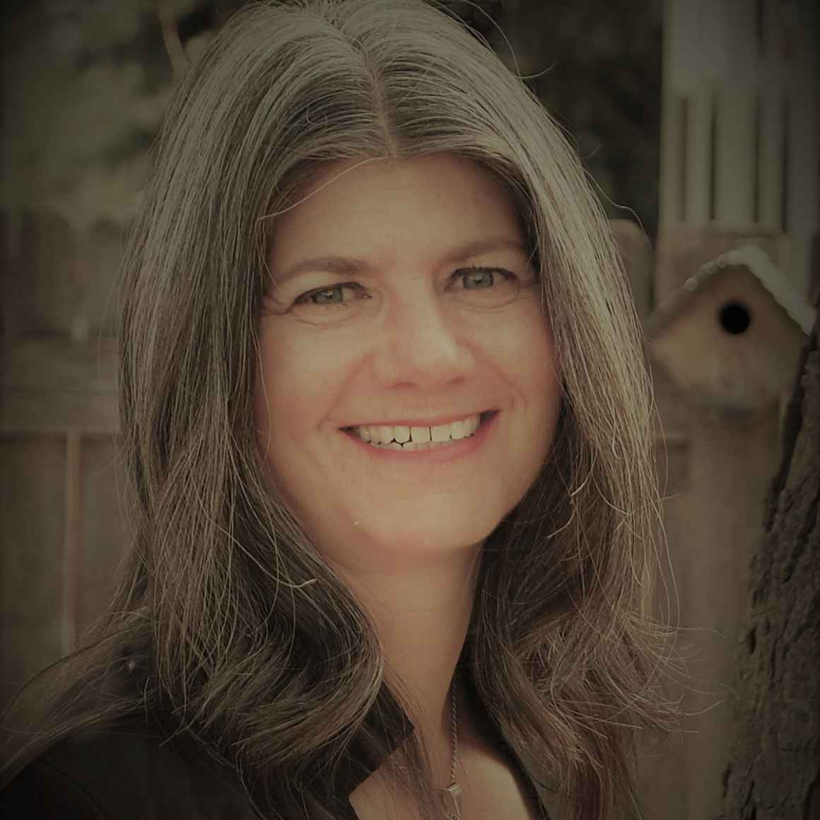Headshot photo of Jennifer Turner, smiling, in front of a light background