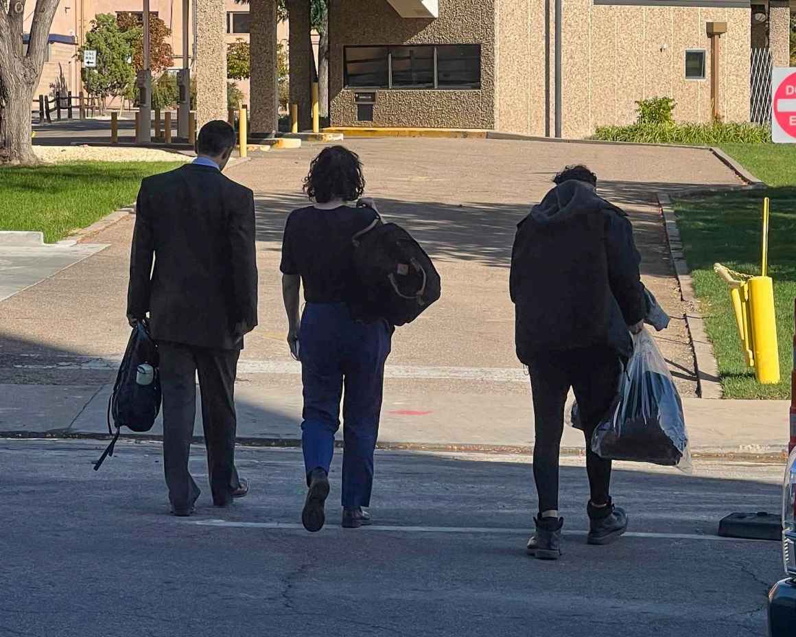 Photo of Dean Lopez and his two attorneys from behind, walking away