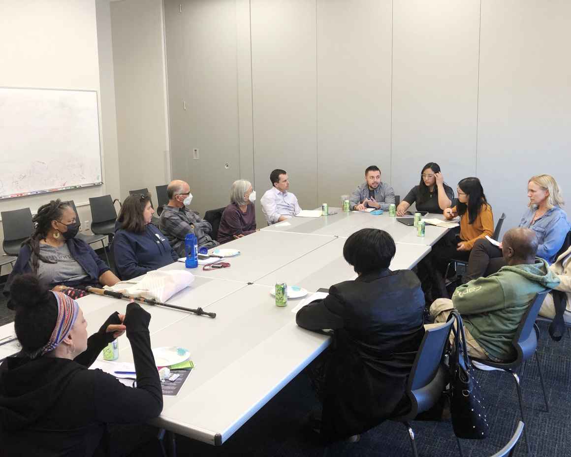 Expanding the Table for Justice event with people having a conversation around a table