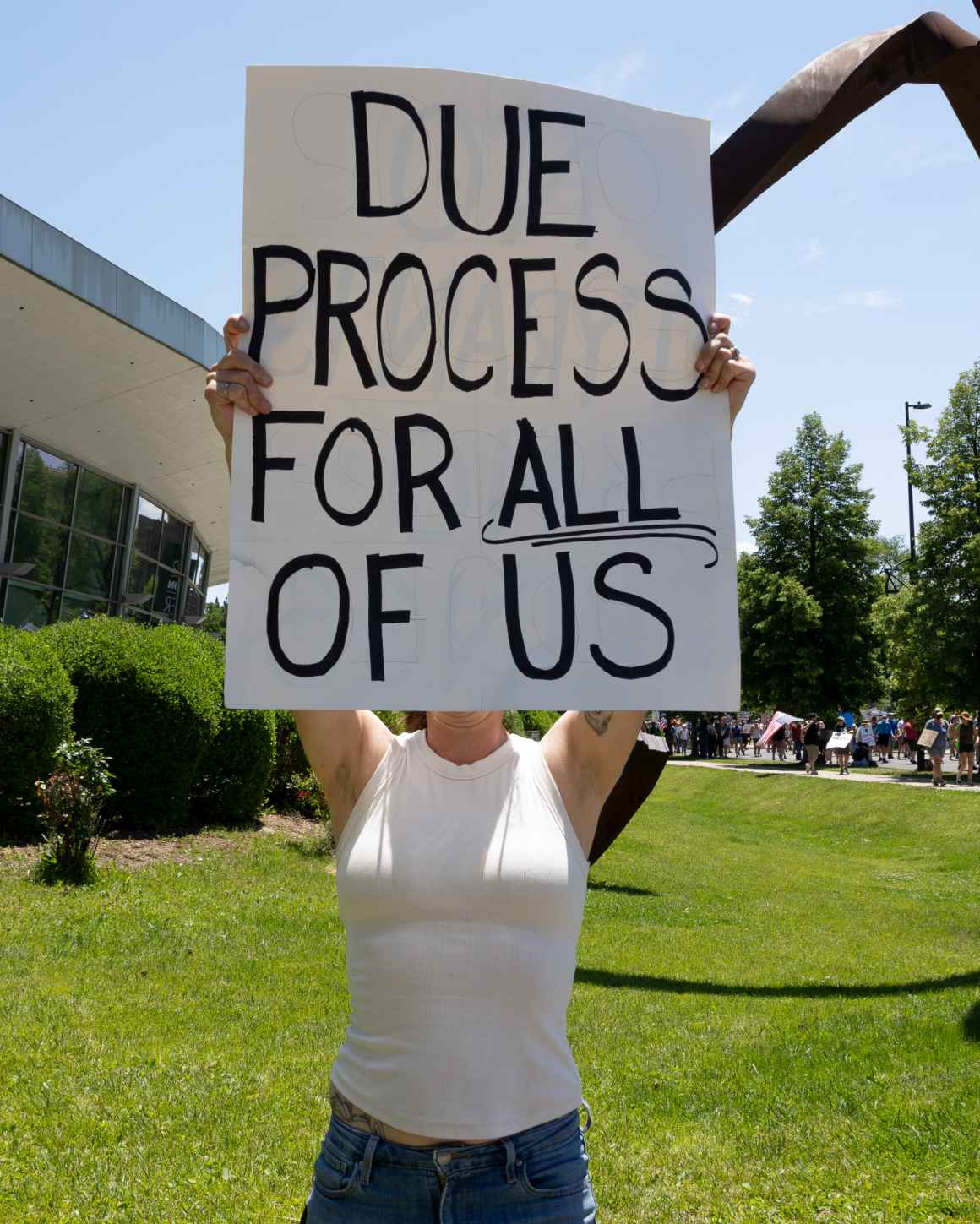A protester holds a sign at a "No Kings" event in Denver on June 14, 2025.