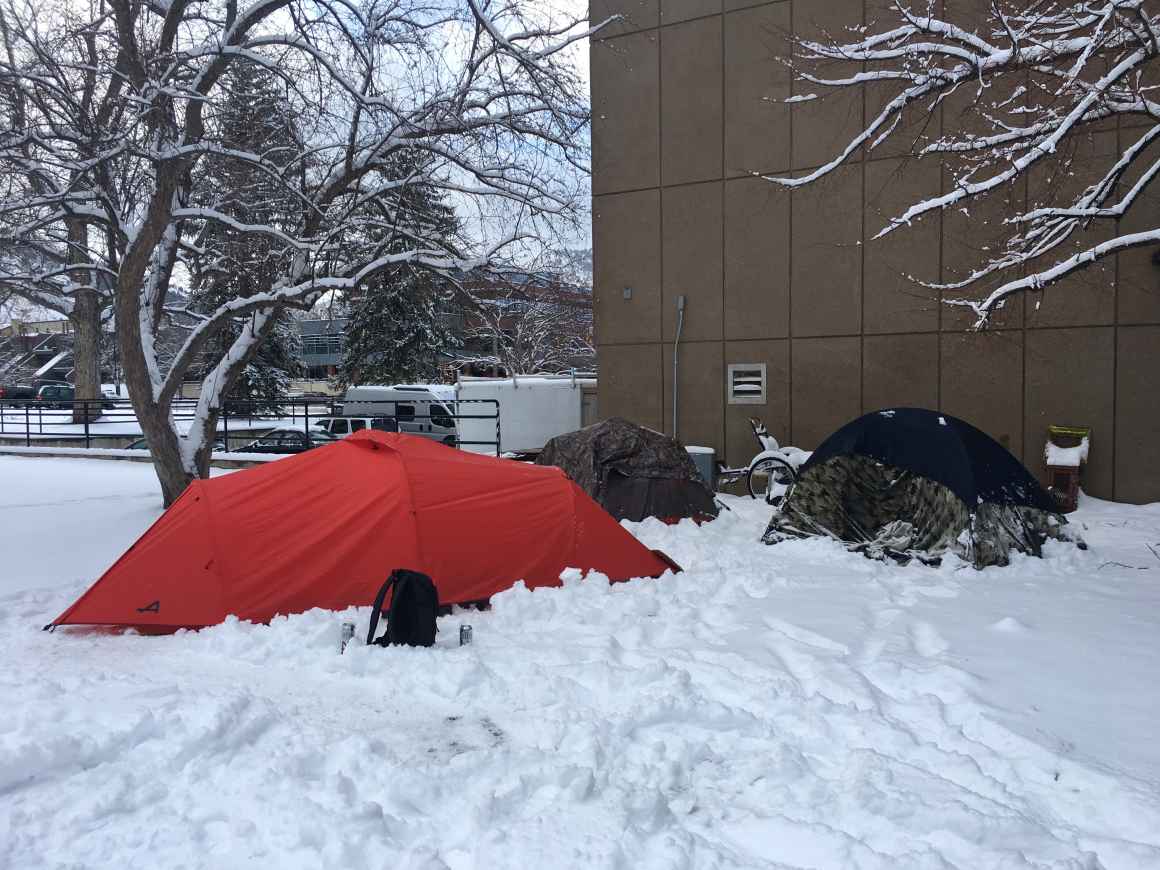 Different colored camping tents standing in snow