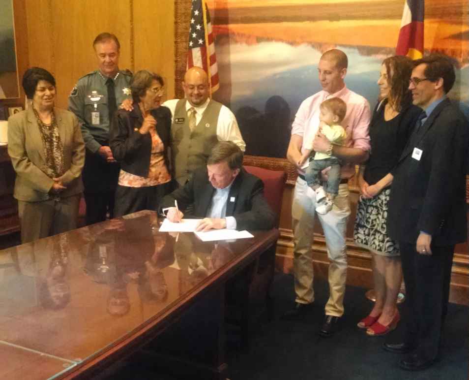 Public Policy Director Denise Maes, Sen. Guzman, Rep. Salazar, Gov. Hickenlooper, Jared Thornburg, Staff Attorney Rebecca Wallace, and Executive Director Nathan Woodliff-Stanley at the bill signing