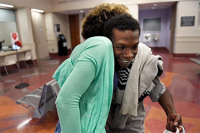 Photo: Elisabeth Epps with the Denver Justice Project welcomes Mickey Howard, of Denvers Five Points as he is released on bail from the Downtown Detention Center.