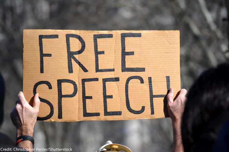 A protest sign that reads "free speech"