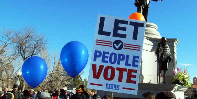 A sign at a protest that reads "Let People Vote"