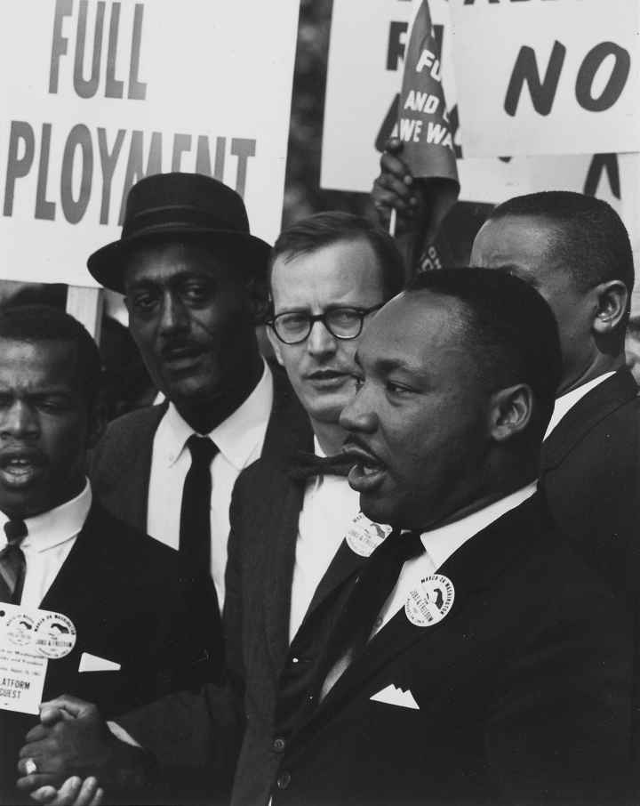 Dr. Martin Luther King Jr. speaking at an event black and white