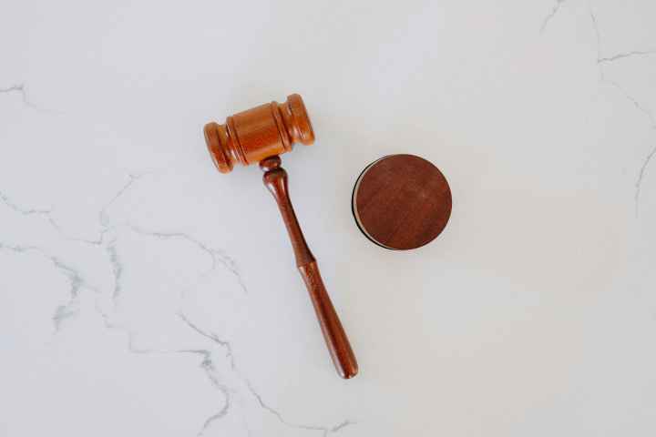 Photo of a gavel laying on white marble