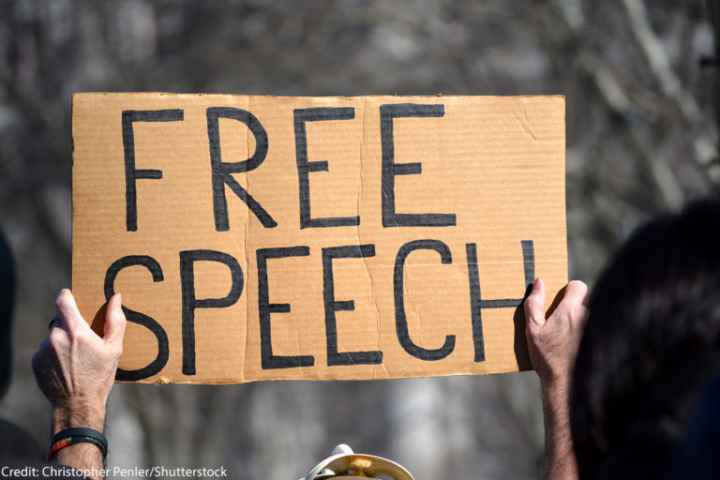 A protest sign that reads "free speech"