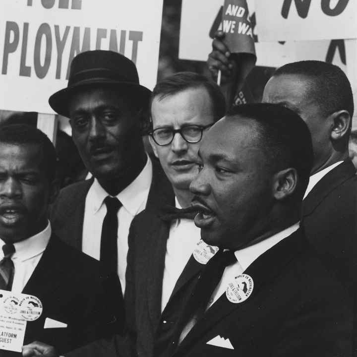 Dr. Martin Luther King Jr. speaking at an event black and white