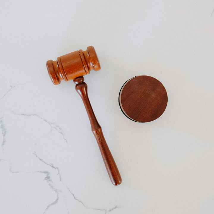 Photo of a gavel laying on white marble